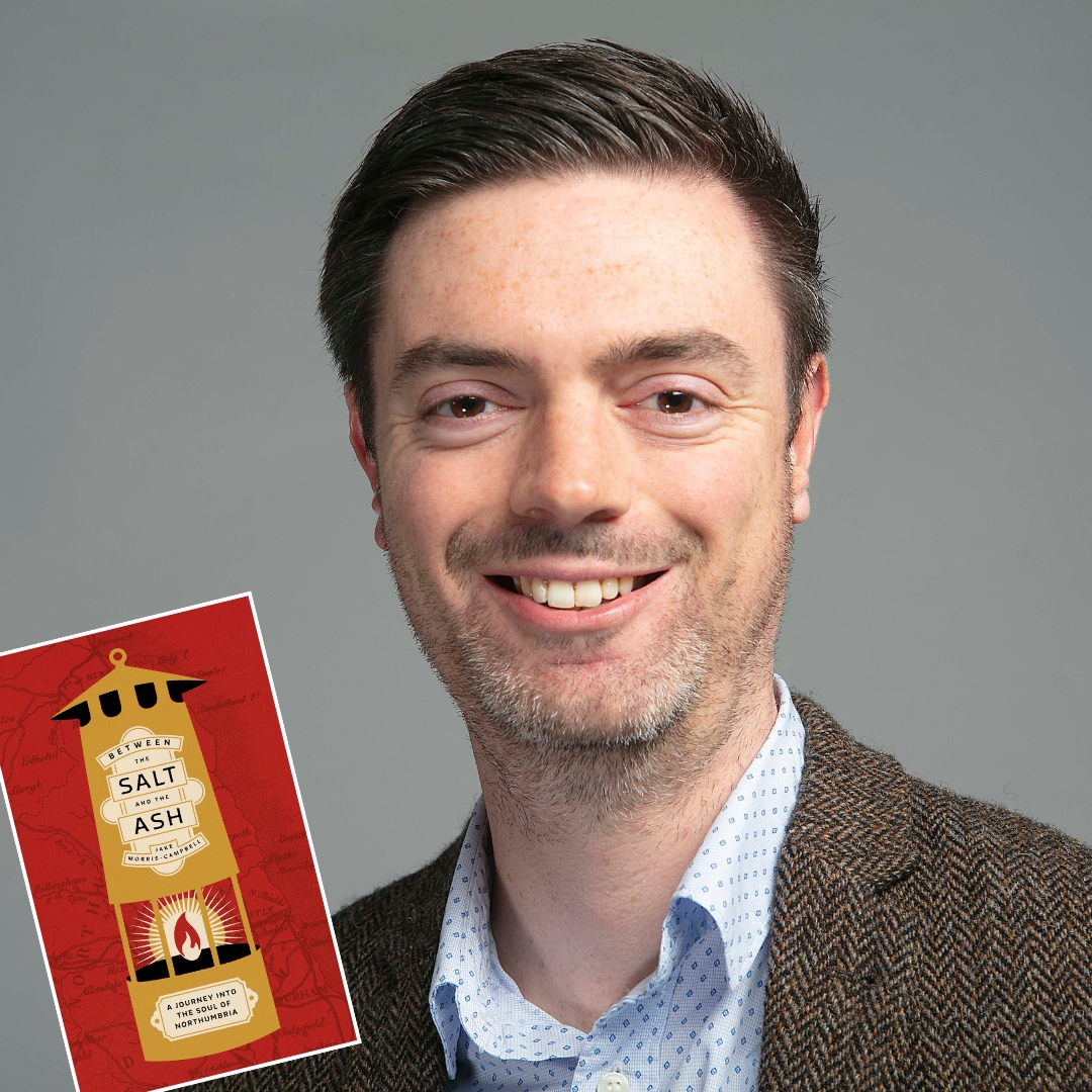 A man with short dark hair smiles confidently, wearing a tweed jacket and patterned shirt. A book cover titled "Salt Ash" is overlaid, featuring a red background and a lighthouse illustration. The mood is professional and inviting.
